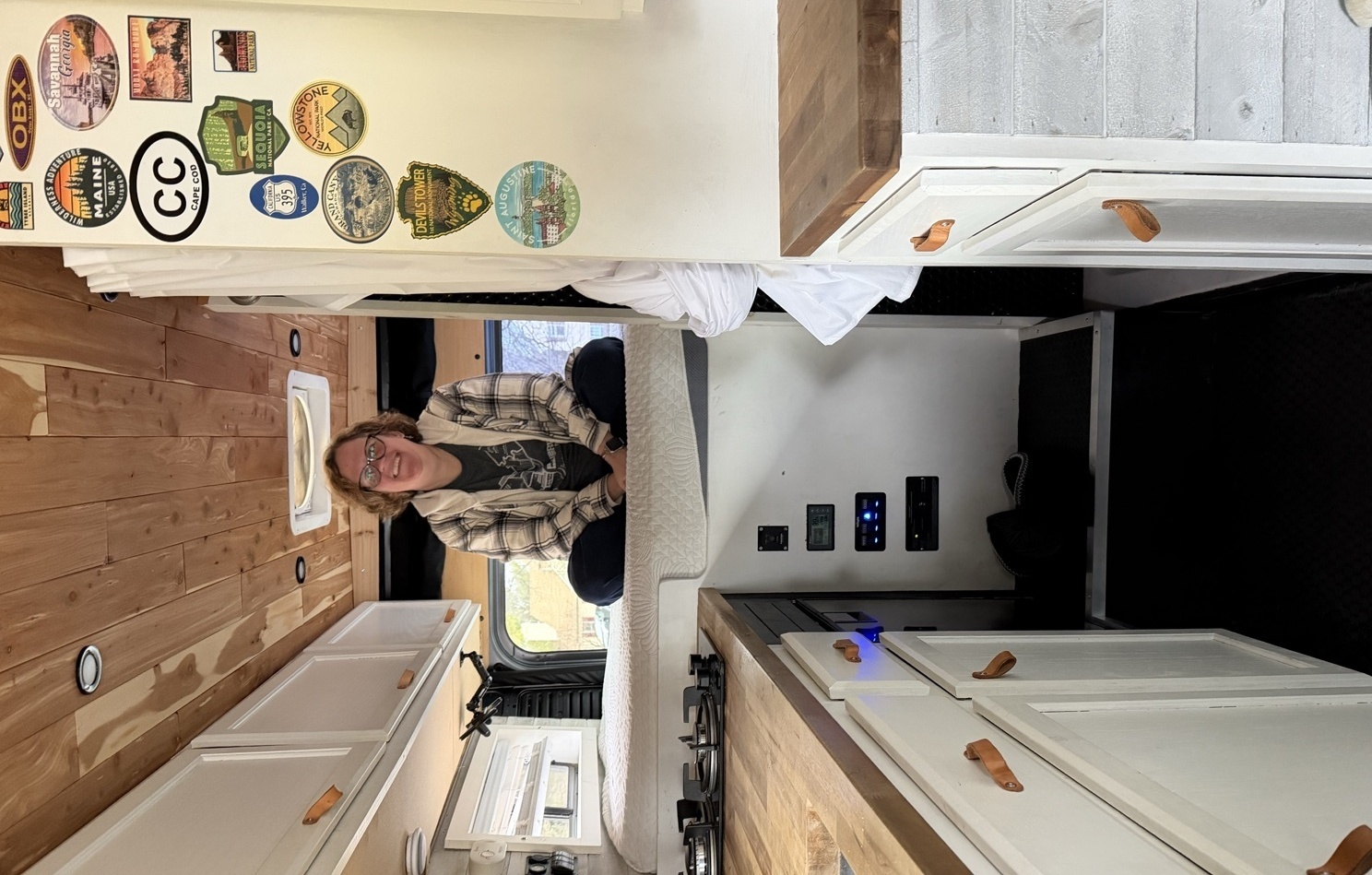 Andrea Michalek sitting in the loft of her van, Bessie